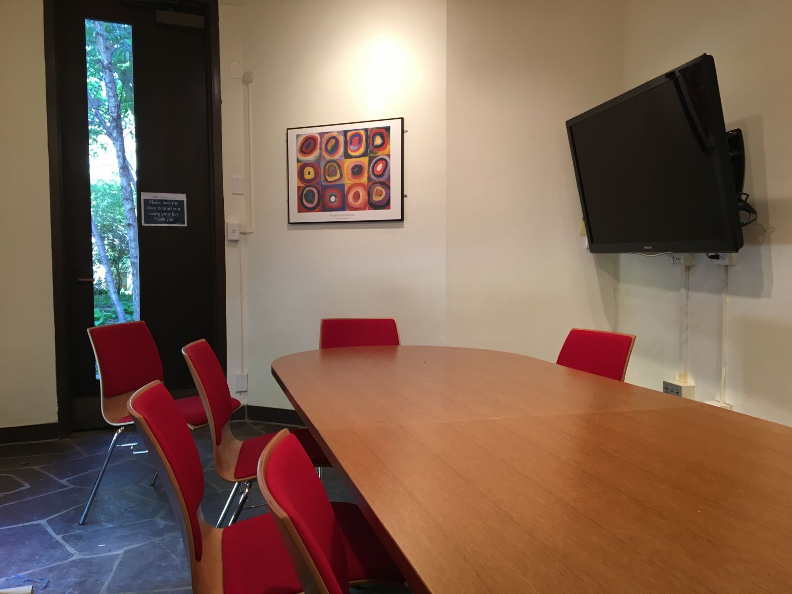 Guardhouse room with a framed painting and small outside view