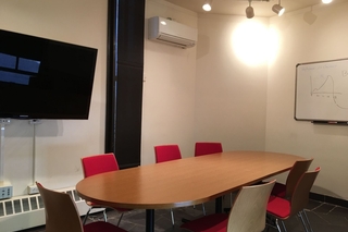 The Guardhouse room with a TV and a whiteboard