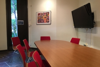 Guardhouse room with a framed painting and small outside view