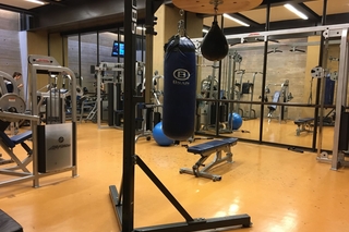 Another angle of the weight room with benches and other workout machine
